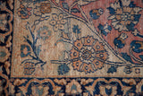 Antique Persian Khorassan rug detail: blanched field with unique alicorn vine motif.