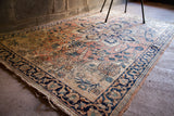 Unique alicorn motif in corner of blanched Persian Khorassan rug, with visible wear.