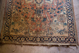 Worn pile and tattered fringe on the blanched corner of this antique Dorokhsh rug.