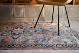 Blanched coral and distressed blue antique Persian Dorokhsh rug detail, showing unique alicorn vine motif.
