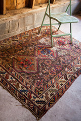 Intricate tribal geometric medallion and surrounding warming patterns with evident wear.