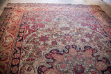 Intricate Safavid-inspired border design on antique Kerman rug, cochineal red, ivory, dark blue.