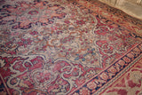 Worn cochineal red and dark blue Safavid-inspired border on an antique Kerman rug.