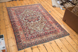Antique Kerman rug's Safavid-inspired border, with worn cochineal red, ivory, and dark blue.