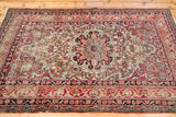 Antique Kerman rug's corner with Safavid-inspired border in cochineal red, ivory, dark blue.