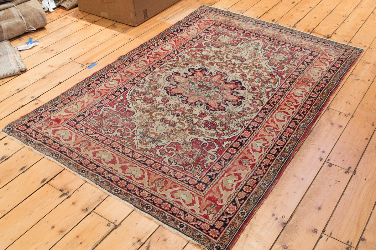 Antique Kerman rug, central scalloped medallion, Safavid inspired border, cochineal red, ivory, dark blue tones.