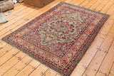 Antique Kerman rug, central scalloped medallion, Safavid inspired border, cochineal red, ivory, dark blue tones.