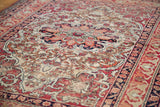 Antique Kerman rug's worn texture, scalloped medallion, and Safavid-inspired border.
