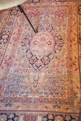 Kerman's central floral medallion, surrounded by cochineal red, blue, and ivory patterns.