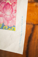 Bottom corner of vintage Chinese poster, showing vertical blue text and paper creases.