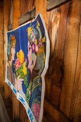 Vintage Chinese poster showing vibrant artwork and its creased, slightly torn edge.