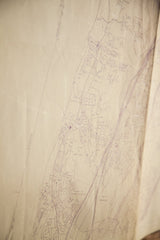 Angled view of the vintage Greenburgh map showing aged paper creases and purple ink detail.
