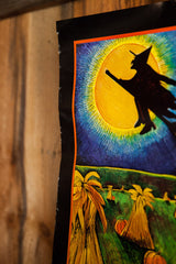 Angled view of the vintage Halloween poster's torn edge and textured illustration.