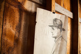 Gentleman sketch: man's profile, bow tie, and torn edge of aged paper.