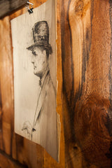 Detail showing aged paper and tattered edge of the gentleman sketch.