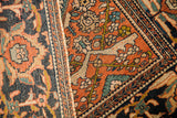 Detailed weave of a Farahan Sarouk's shadowed samovar motif and herati border.