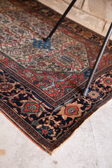 Corner of a collector's Farahan Sarouk with intricate red, blue, and ivory Herati motifs.