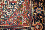 Detailed corner of a fine Farahan Sarouk with its shadowed samovar motif in the red spandrel.