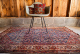 Deep indigo blue field of a fine Herati rug, showcasing abashed tones and red borders.