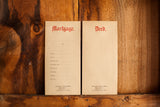 Antique mortgage and deed envelopes, embossed red lettering on aged cream paper.