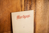 Red embossed 'Mortgage' lettering on an antique 1930s era envelope.