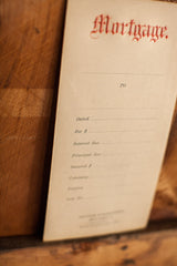 Embossed red 'Mortgage' title on an antique 1930s envelope front.