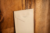 Antique envelope back showing Chisholm Printing Company details on aged paper.