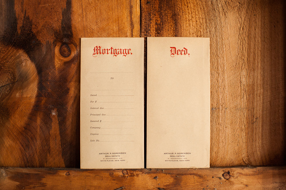Antique 1930s House Deed and Mortgage envelopes with aged paper and raised red lettering.