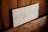 Vintage cream-colored note with funny cursive handwriting.