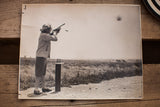 Vintage photograph's bottom right corner with a crease and faint handwritten mark.