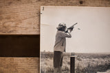 Detail of vintage Carole Lombard photograph showing upper corner crease and aiming rifle.
