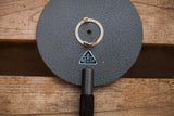 Vintage German Oculus eye equipment logo, showing textured gray disk surface.