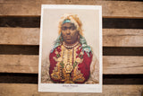 A vintage lithograph portrait of an African Princess in ornate red, gold, and turquoise attire.