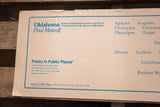 Close-up of the title and author on the vintage Metcalf poster showing the aged paper and frayed corner.