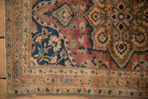 Detailed corner of a rare antique Farahan Sarouk rug showing the fine weave and rich, patinated colors.