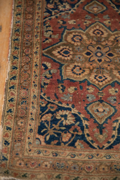 Detailed corner of a collector Farahan rug, showing the fine wool weave and storied floral border.