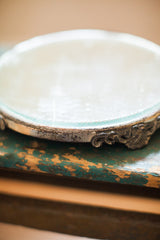 Aged silver-plated frame with intricate scrollwork and beveled glass edge detail.