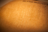 Embossed 'Currency Ledger' watermark on the gridded paper of an antique railway log.