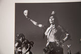 Native American dance ceremony photo, black and white, with man holding ceremonial object aloft.