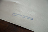 Artist D.R. Peretti Griva's royal blue ink stamp on the textured reverse of the Fabriano paper.