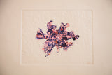 Abstract etching with mottled pink, blue, and red texture and soft patina.