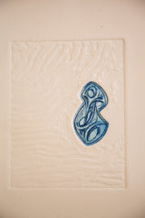 Detail of a blue abstract etching, showcasing intricate swirling patterns and textured paper.
