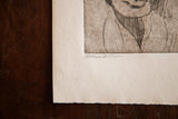 Illegible pencil signature and artist-cut raw paper edge on the etching's lower left.