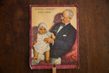 Vintage Putnam Dyes advertising fan with a color lithograph of an elderly man holding a baby.