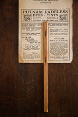 Reverse of vintage Putnam fan with ads for dyes, tints, and a dry-cleaner.