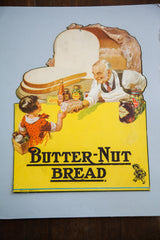 Vintage Butter-Nut Bread advertising sign shown on its light blue mounting board.