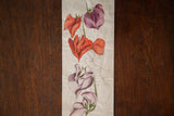 Detail of antique Orchid watercolor showing red and light purple flowers and unfinished sketch.