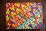 Vintage art with exploratory geometric lattice pattern of colorful triangles on heavy card stock.