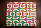 Vintage geometric harlequin ink art on card stock, pink, green, orange, red diamonds.