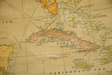Antique wall map detail: Cuba, Jamaica, and Caribbean Sea in faded orange and green.